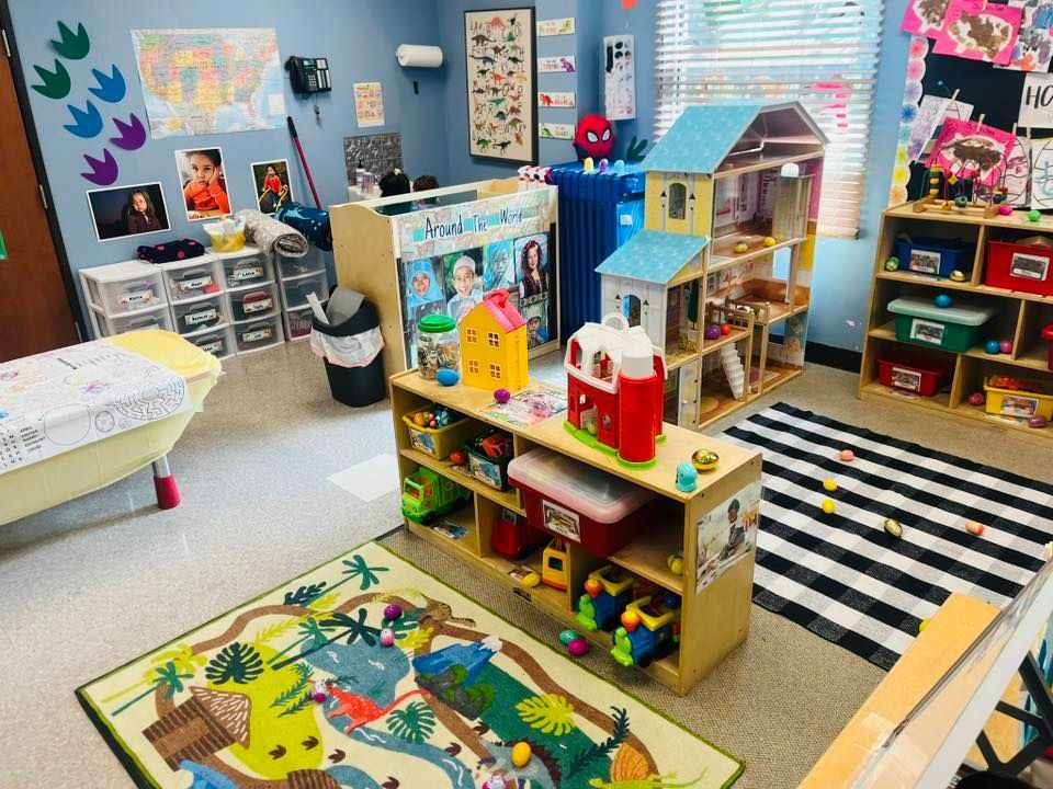 Colorful classroom with dollhouses, toy shelves, rugs, and play materials in a child play area