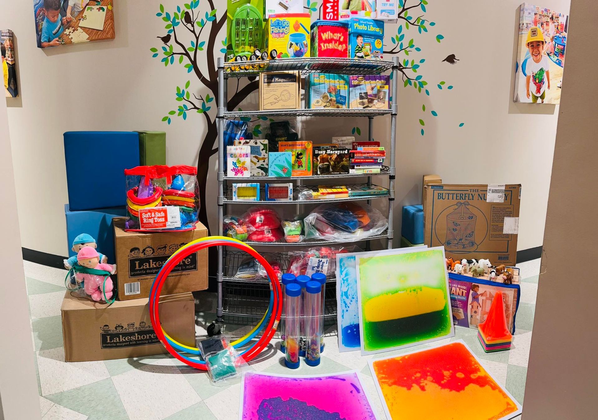 Colorful toy and craft display on shelves and table, with boxes and containers in a room