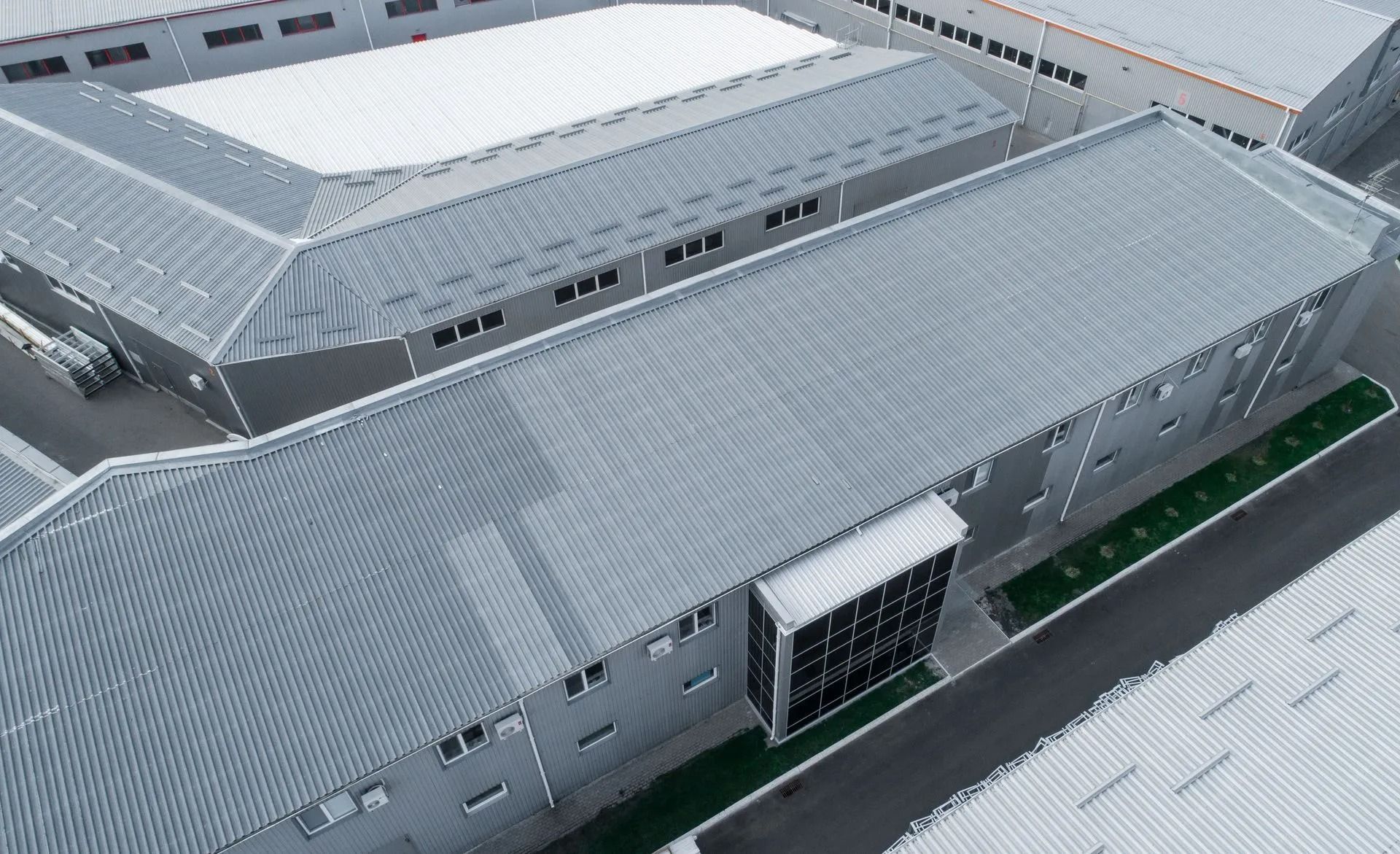 Aerial view of industrial buildings with corrugated metal roofs.