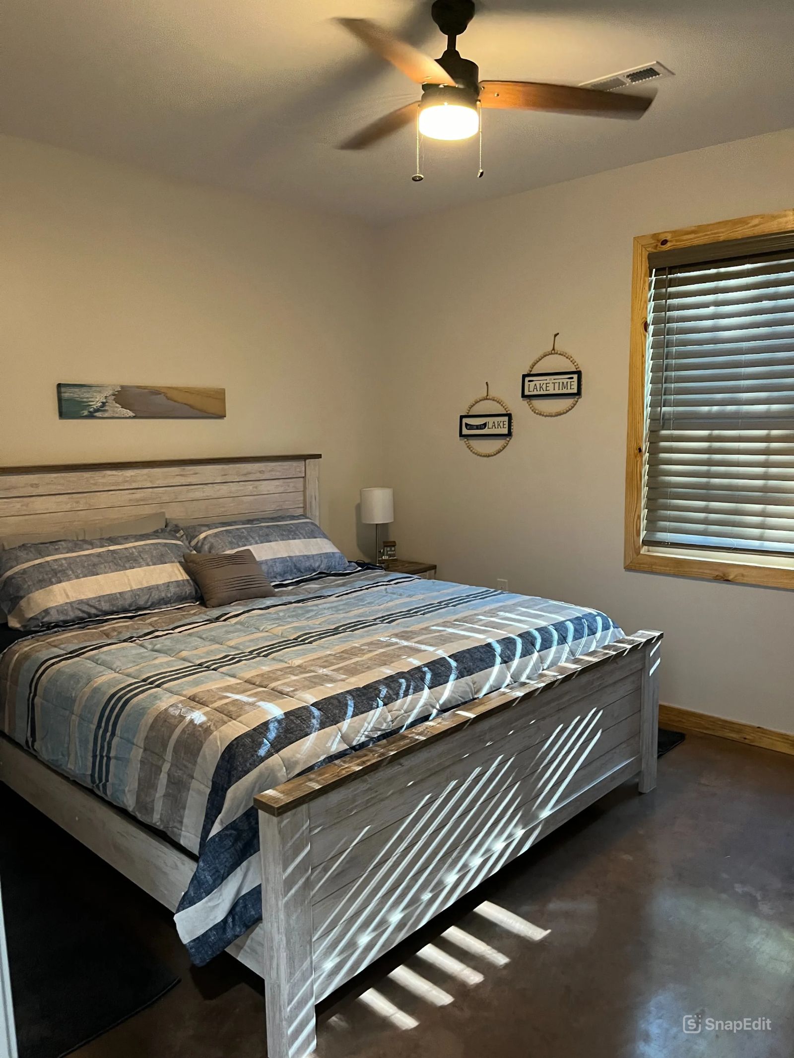 A bedroom with a bed and a ceiling fan