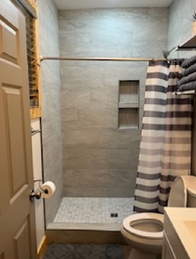 A bathroom with a shower cover