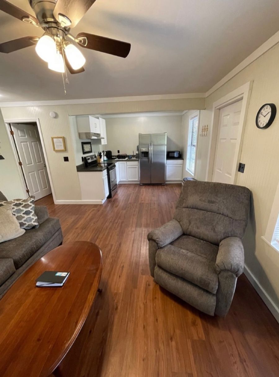 A living room with a recliner and a ceiling fan