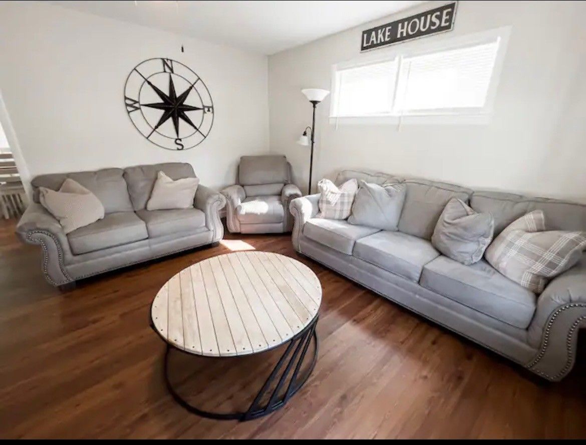 A living room with two couches and a round coffee table.