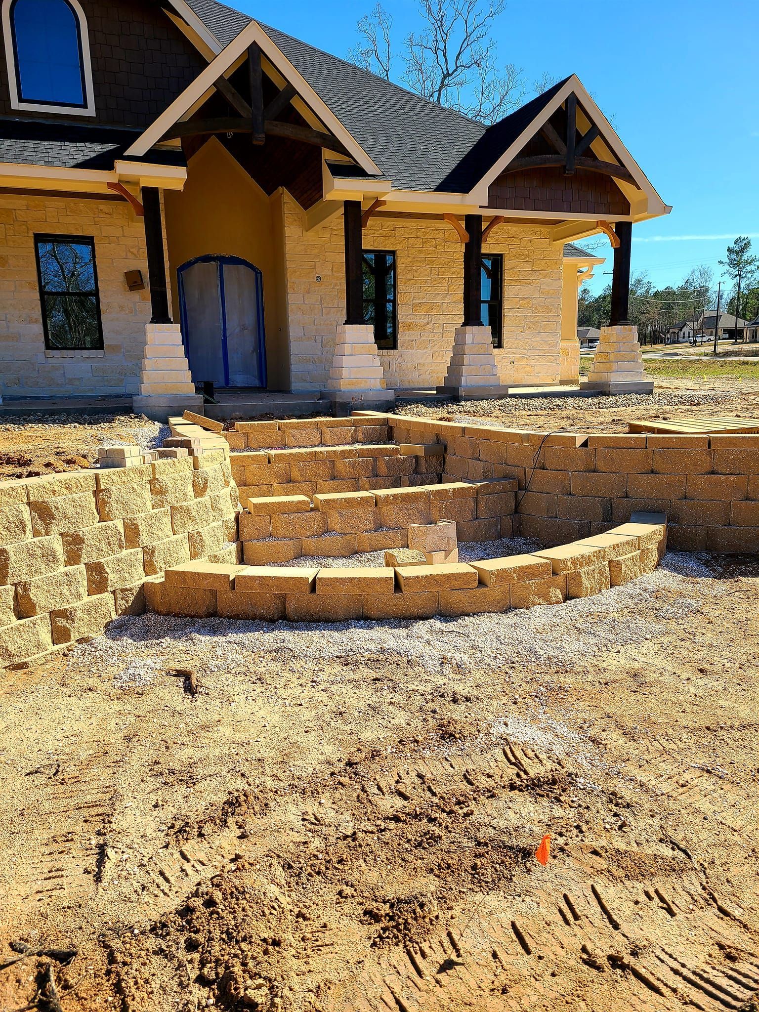 A house is being built in the middle of a dirt field