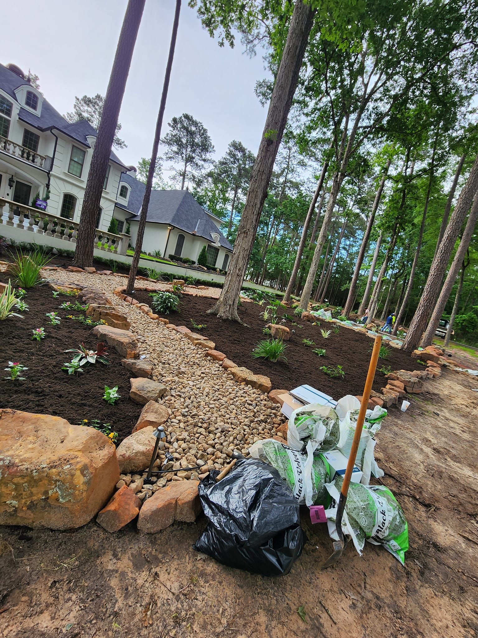 A pile of trash is sitting on the ground in front of a house