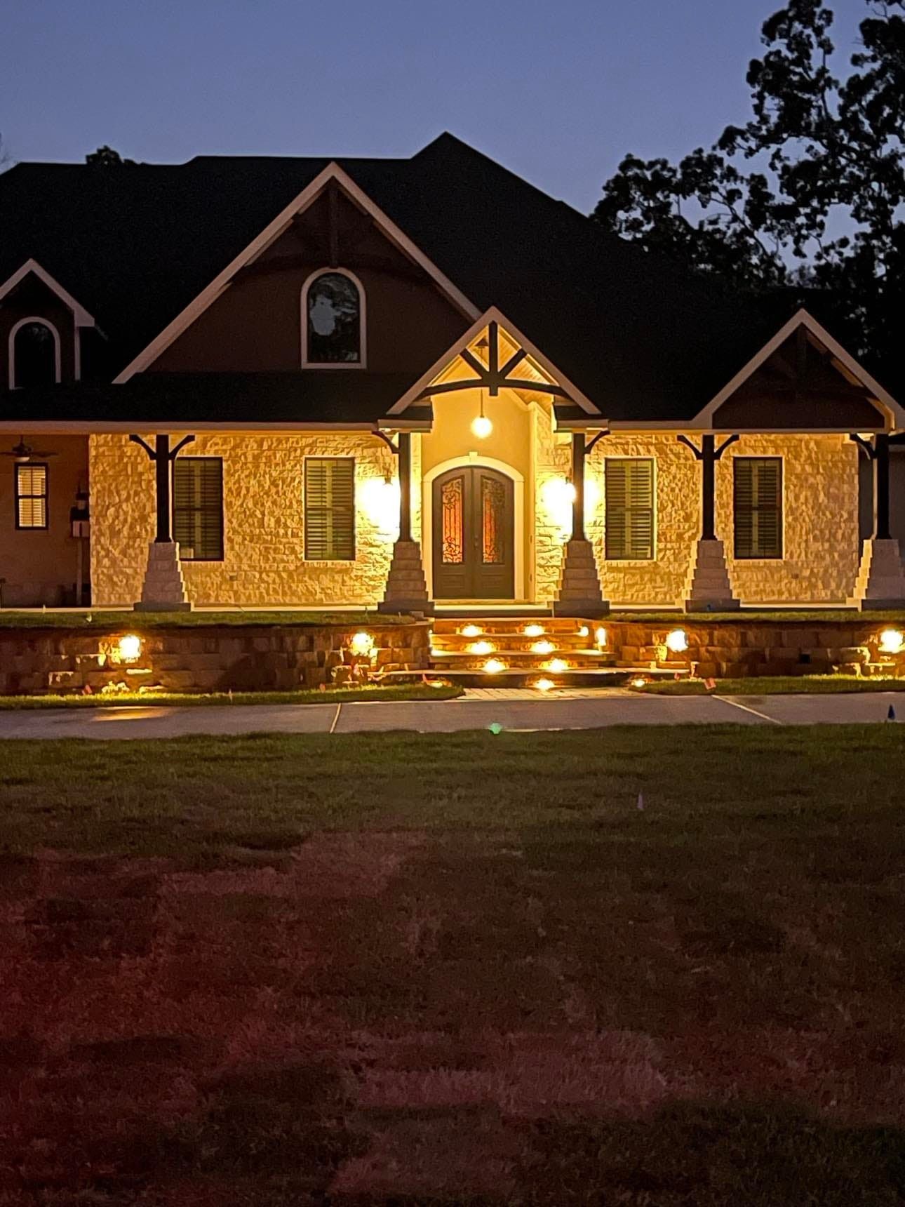 The front of a house is lit up at night