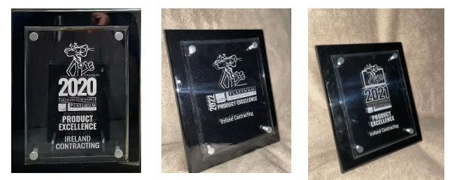 Three plaques with the year 2020 on them are sitting on a table.