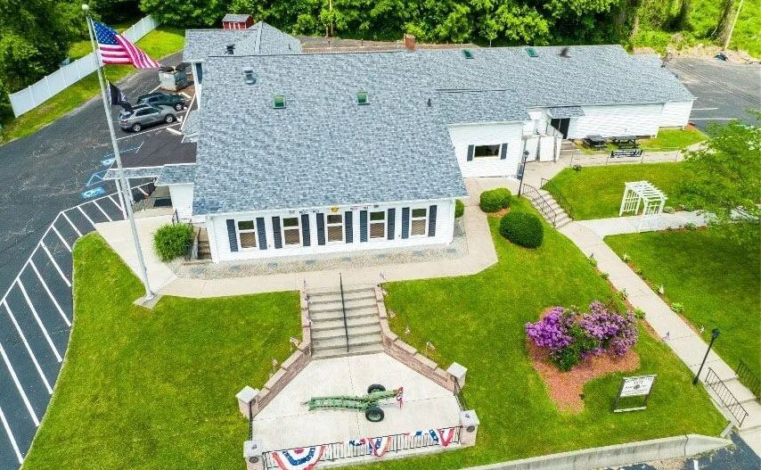 An aerial view of a building with a flag on the roof.