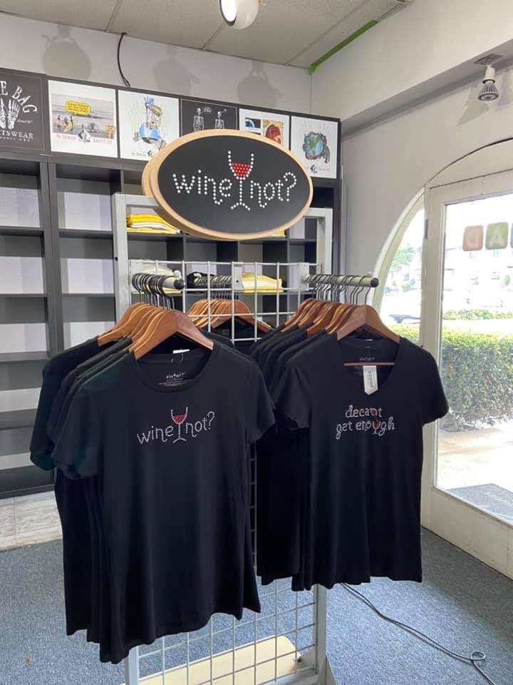 Black t-shirts on a rack, with 