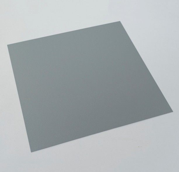 Gray square sheet of paper on a light surface