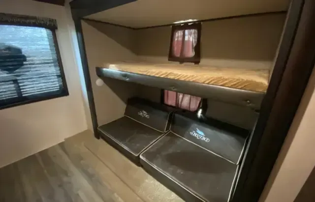 There is a bunk bed in the corner of the room.