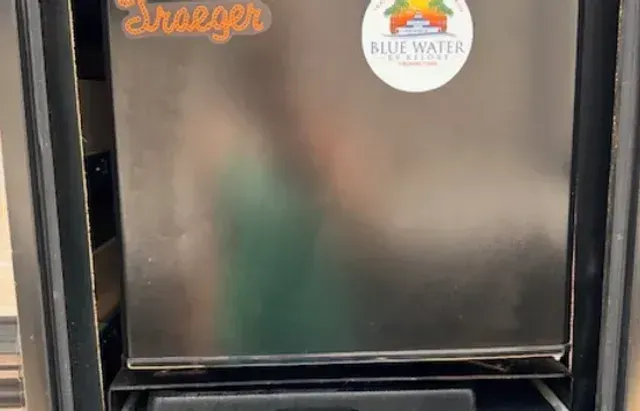 A stainless steel refrigerator with a sticker on the door.