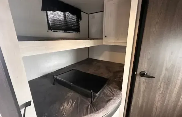 There is a bunk bed in the corner of the room.