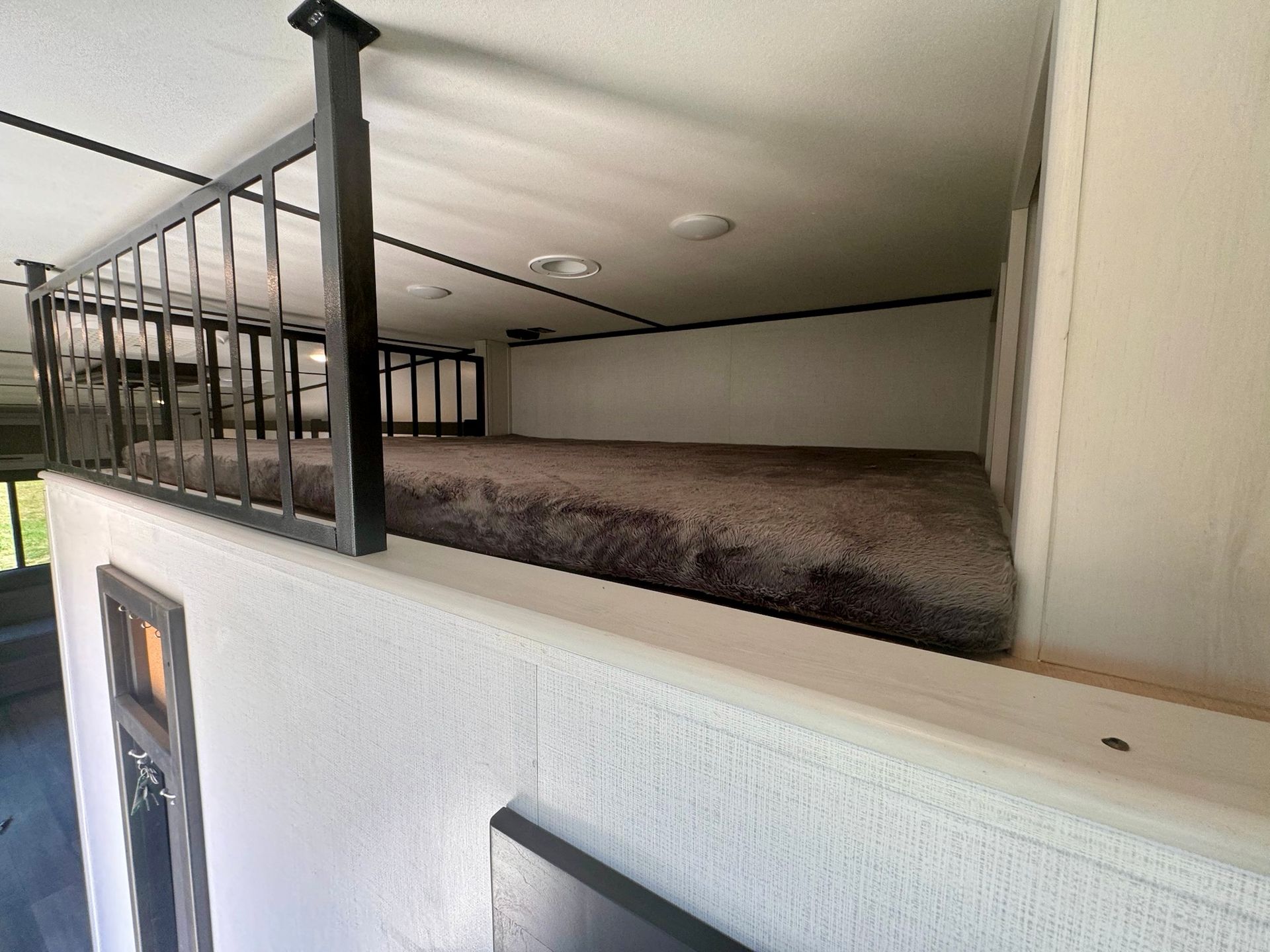 There is a bed in the corner of the room.