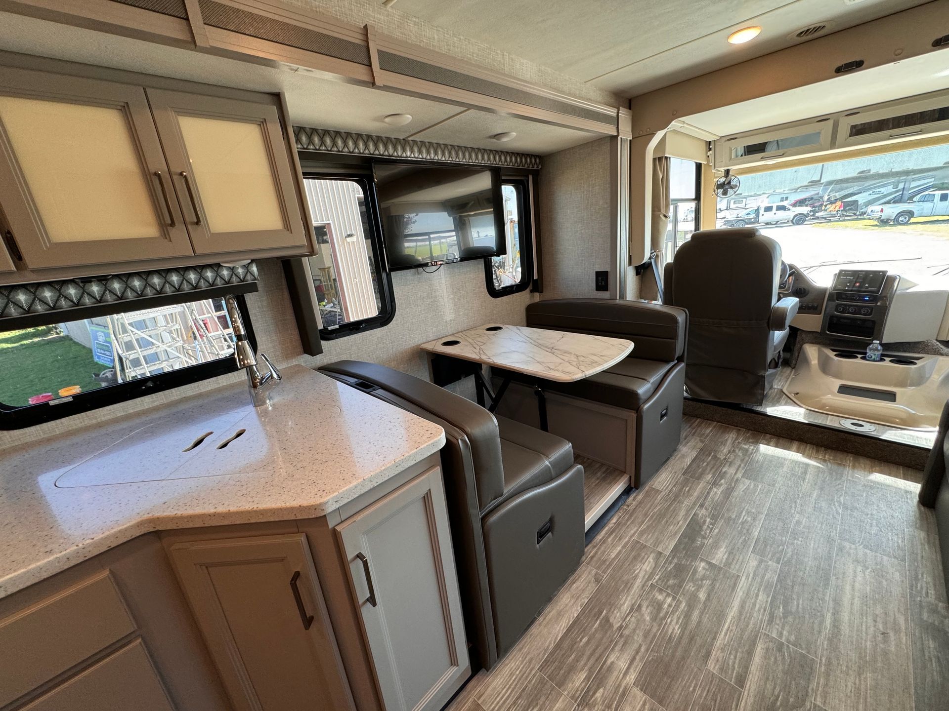 The inside of a rv with a table and chairs.