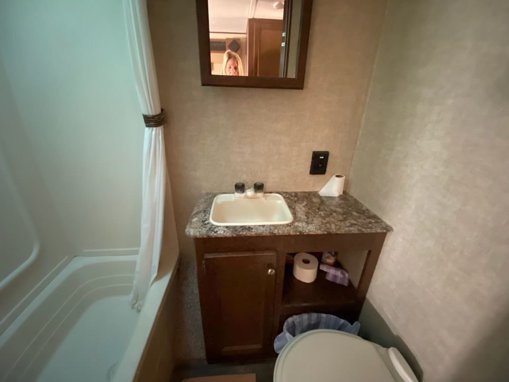 A bathroom with a sink , toilet , and mirror.