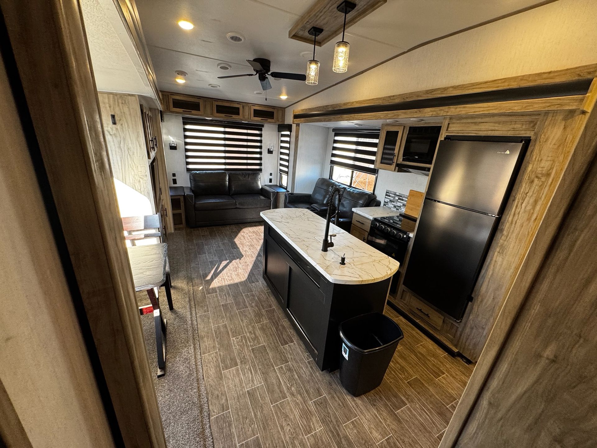 A living room with a couch and a kitchen in a rv.