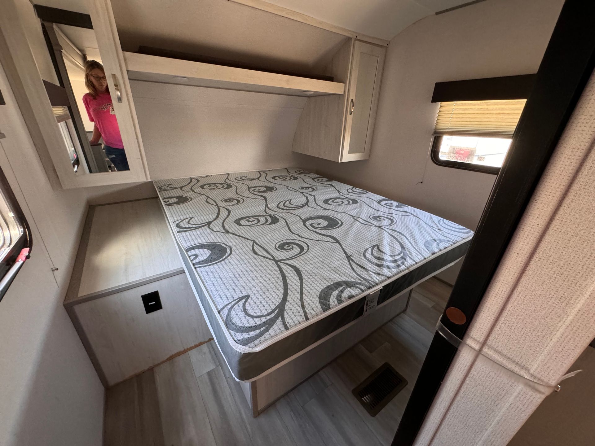 A mattress is sitting on top of a bed in a trailer.