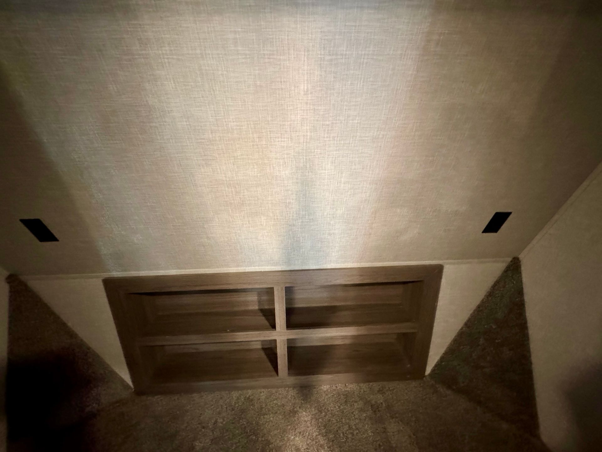 Looking up at the ceiling of a room with shelves.