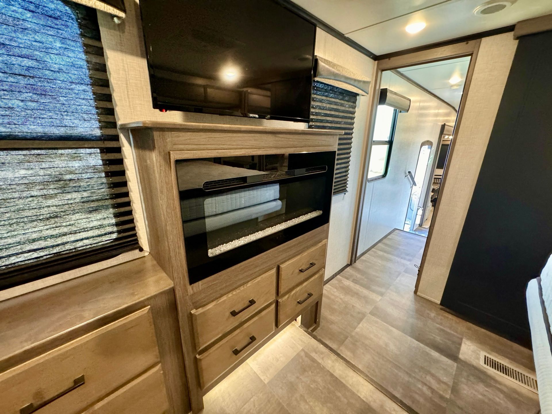 A rv with a flat screen tv on top of a dresser.