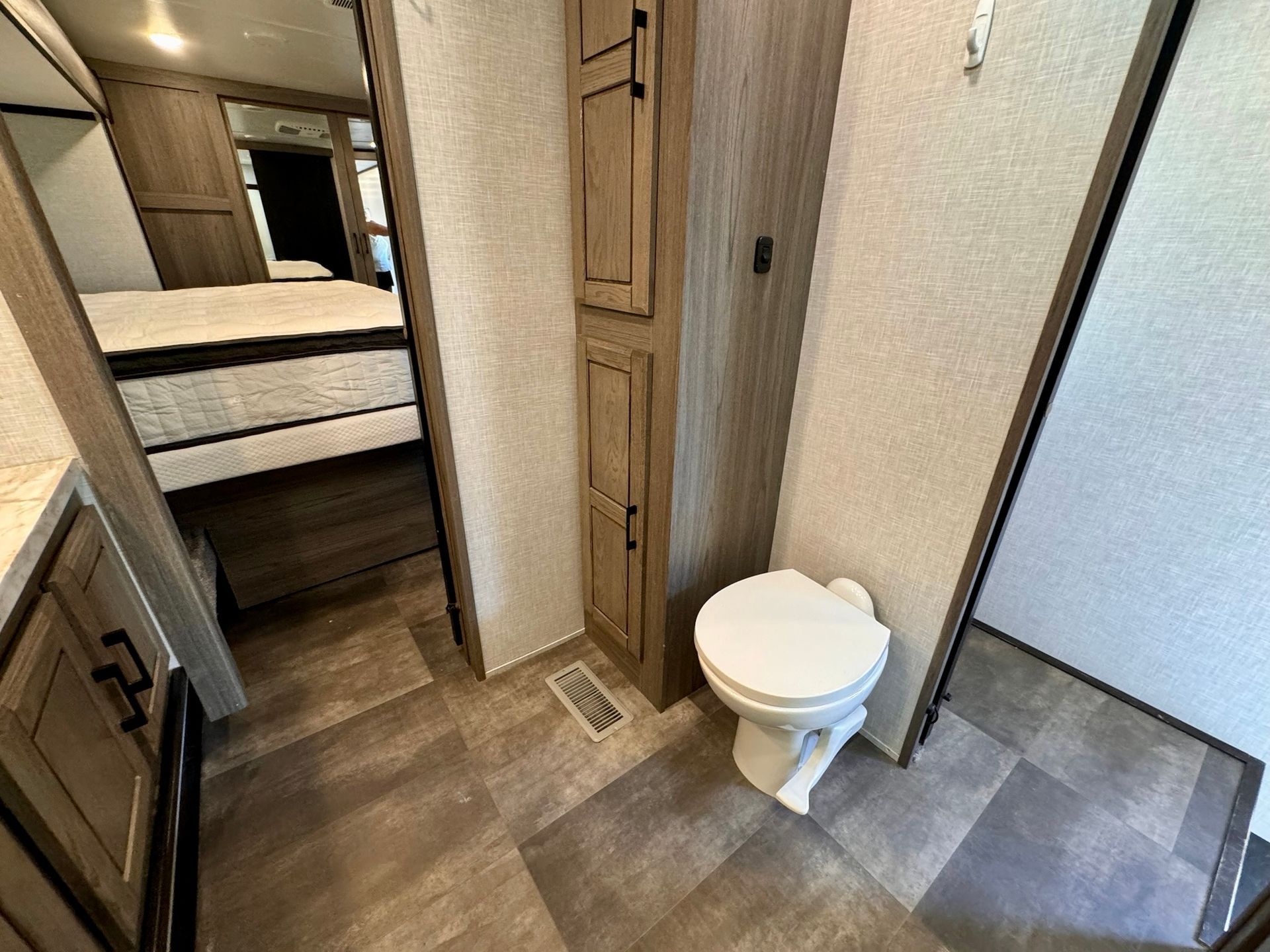 A bathroom in a mobile home with a toilet and a sink.