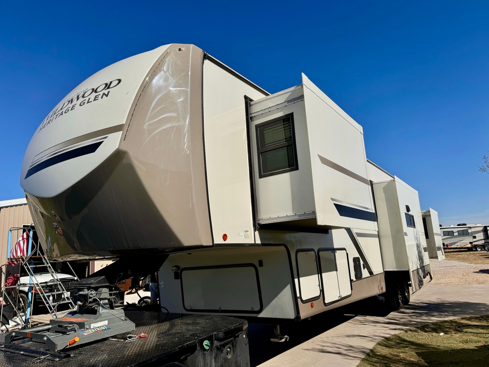 A large rv is parked on the side of the road.