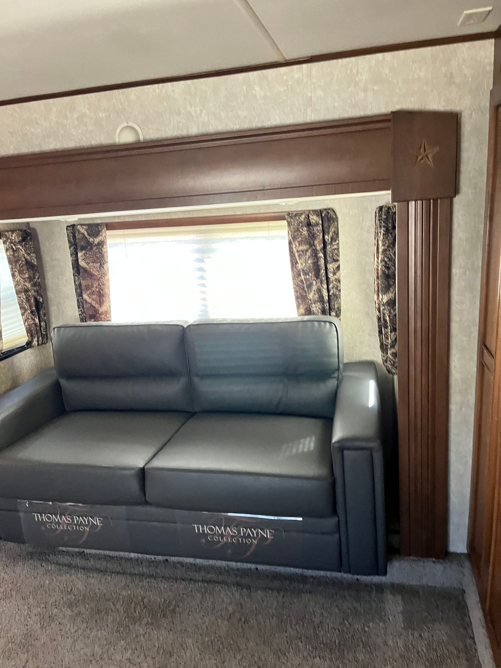 A living room with a couch and a window