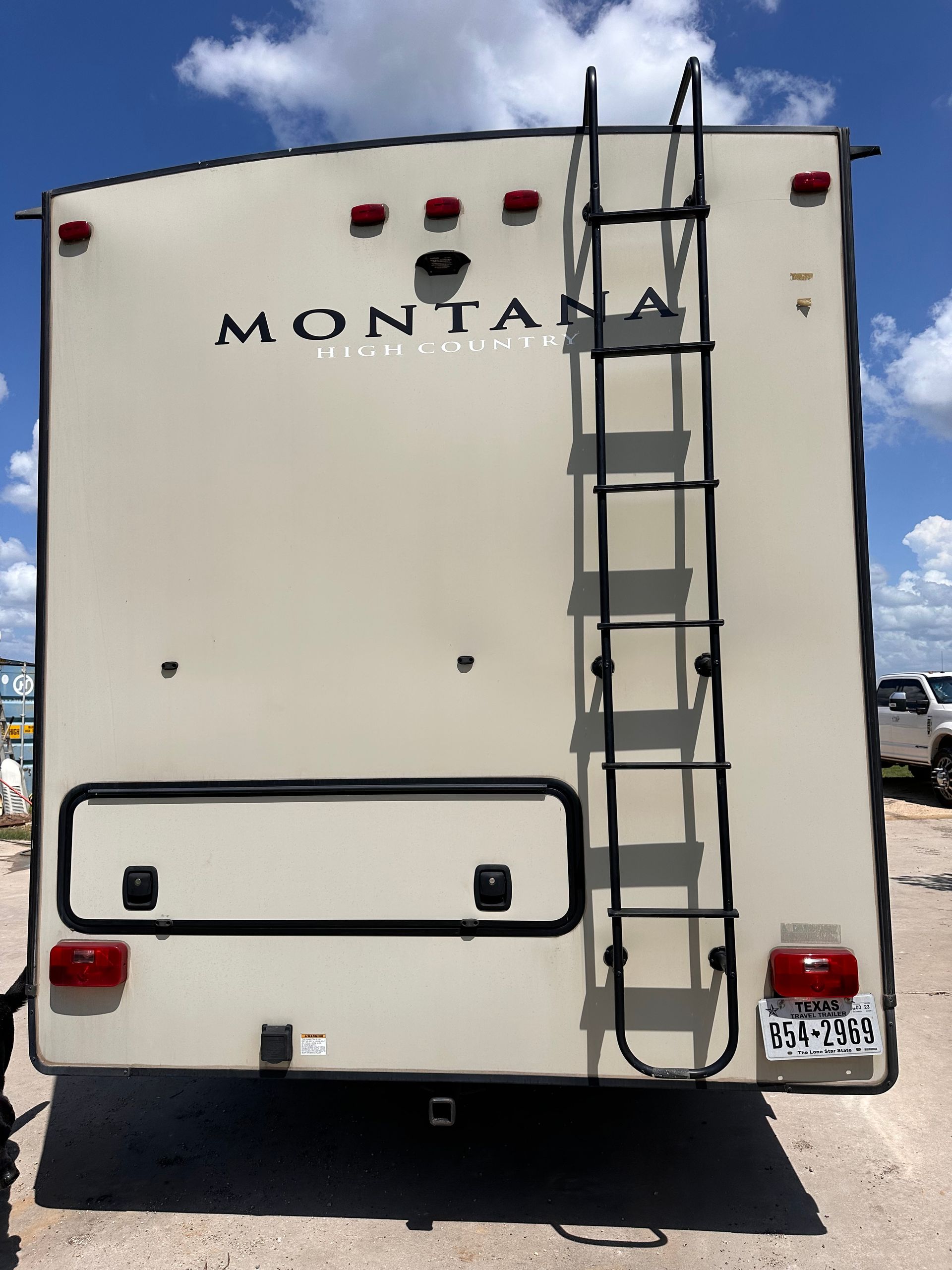 A montana trailer with a ladder attached to the back