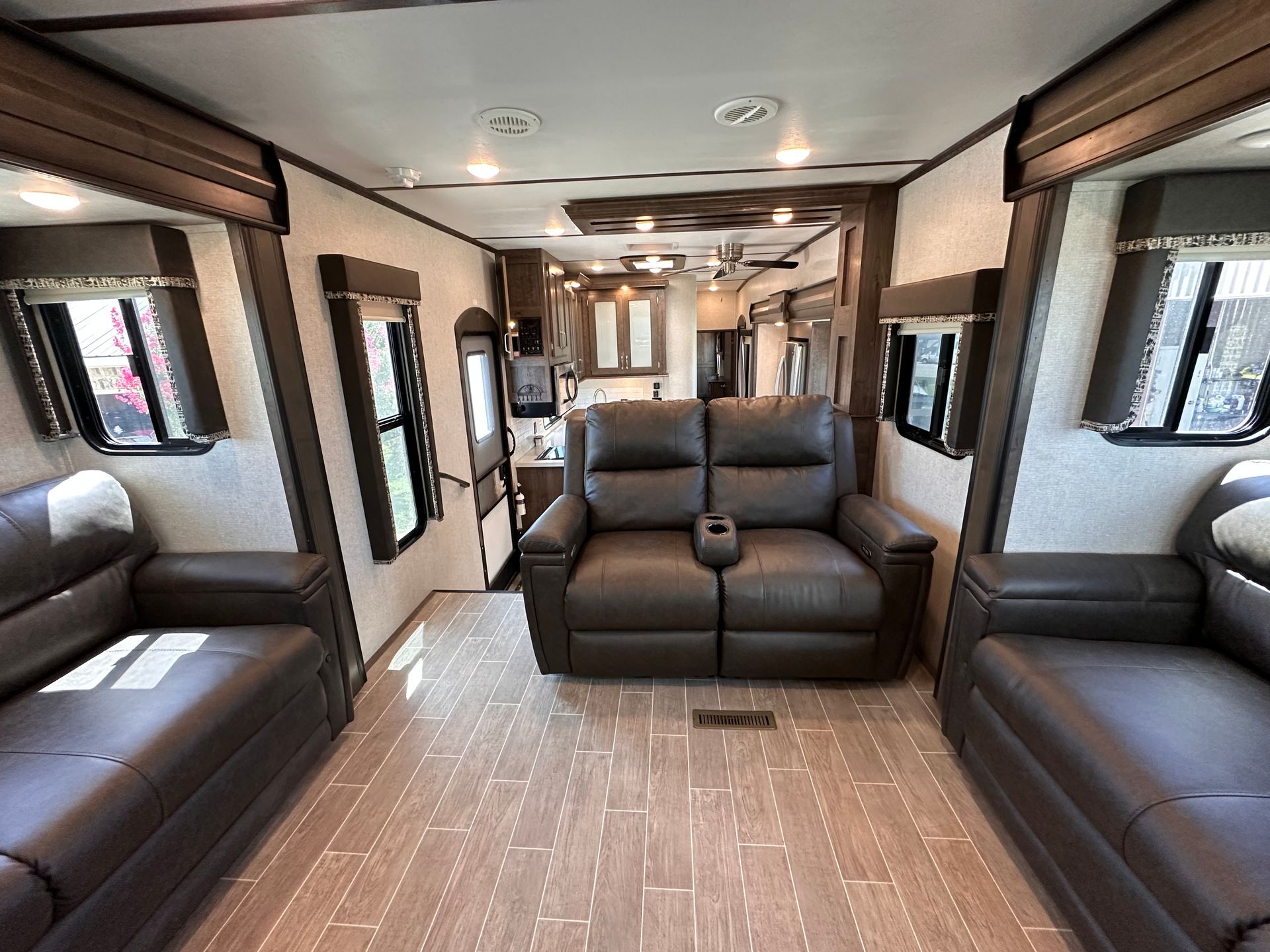 A living room with two couches and a chair