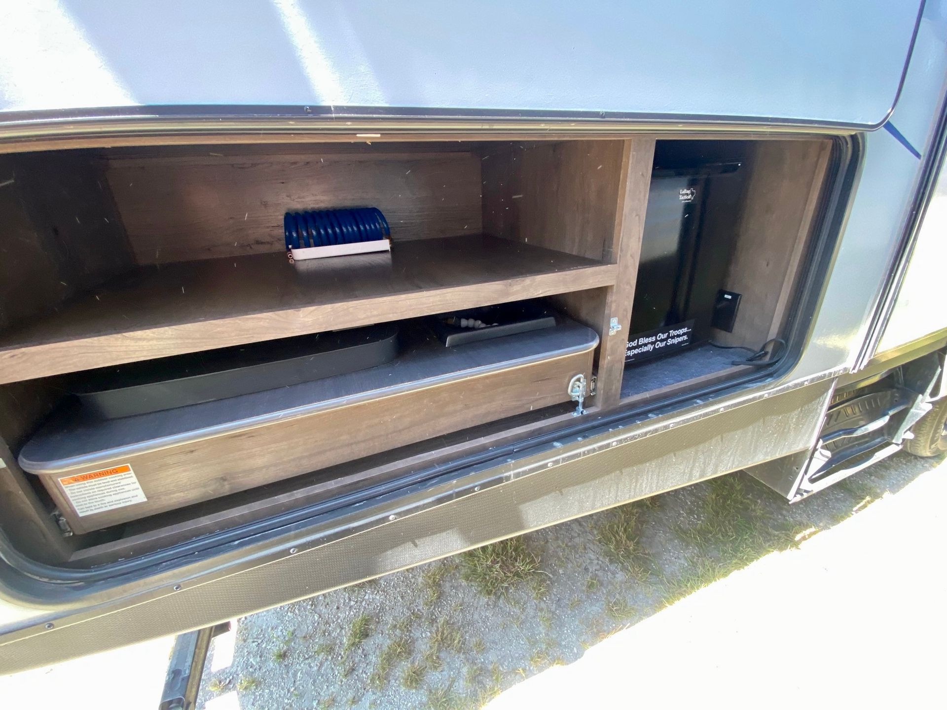 A rv with a shelf and a drawer underneath it.