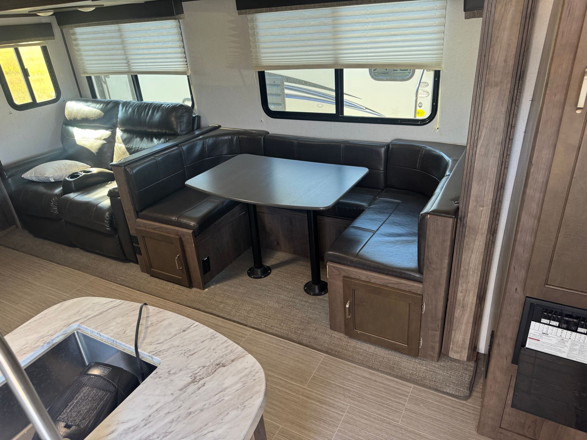 A rv with a table and chairs in the living room.