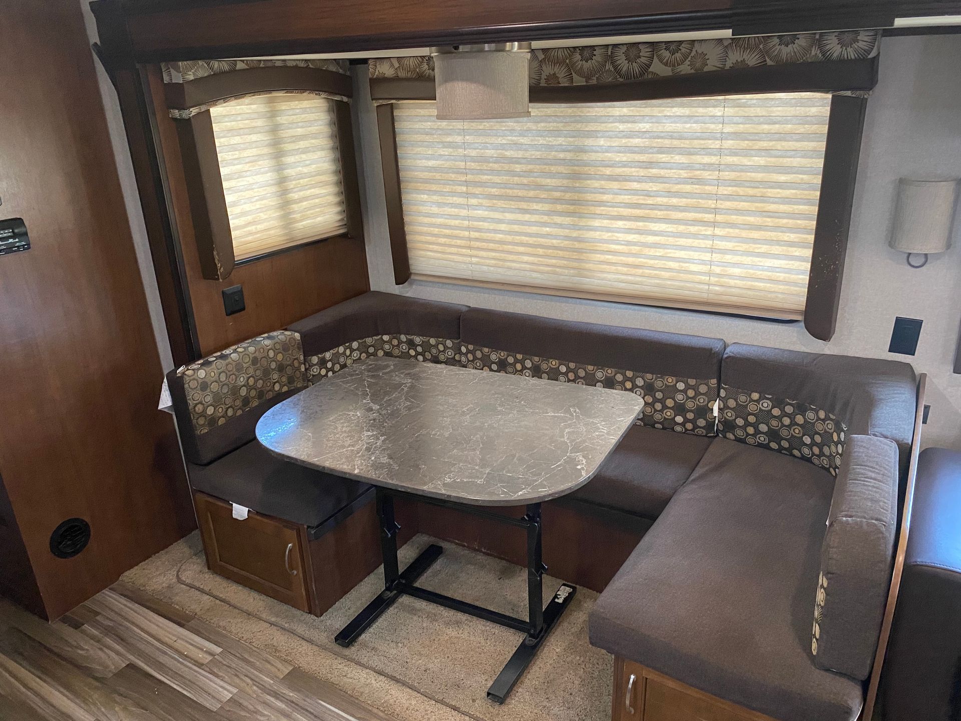 A rv with a table and couch in it.