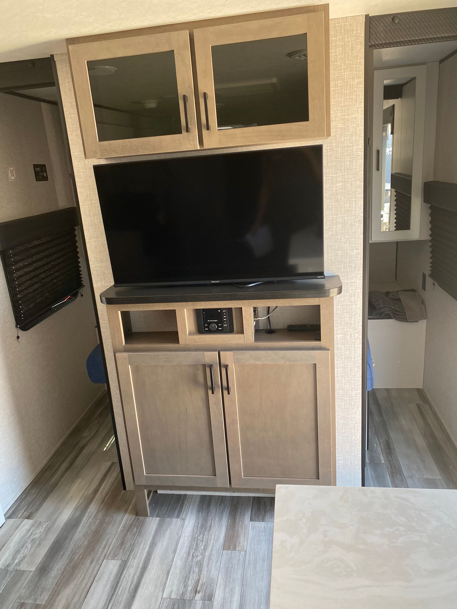 A flat screen tv is sitting on top of a cabinet in a rv.