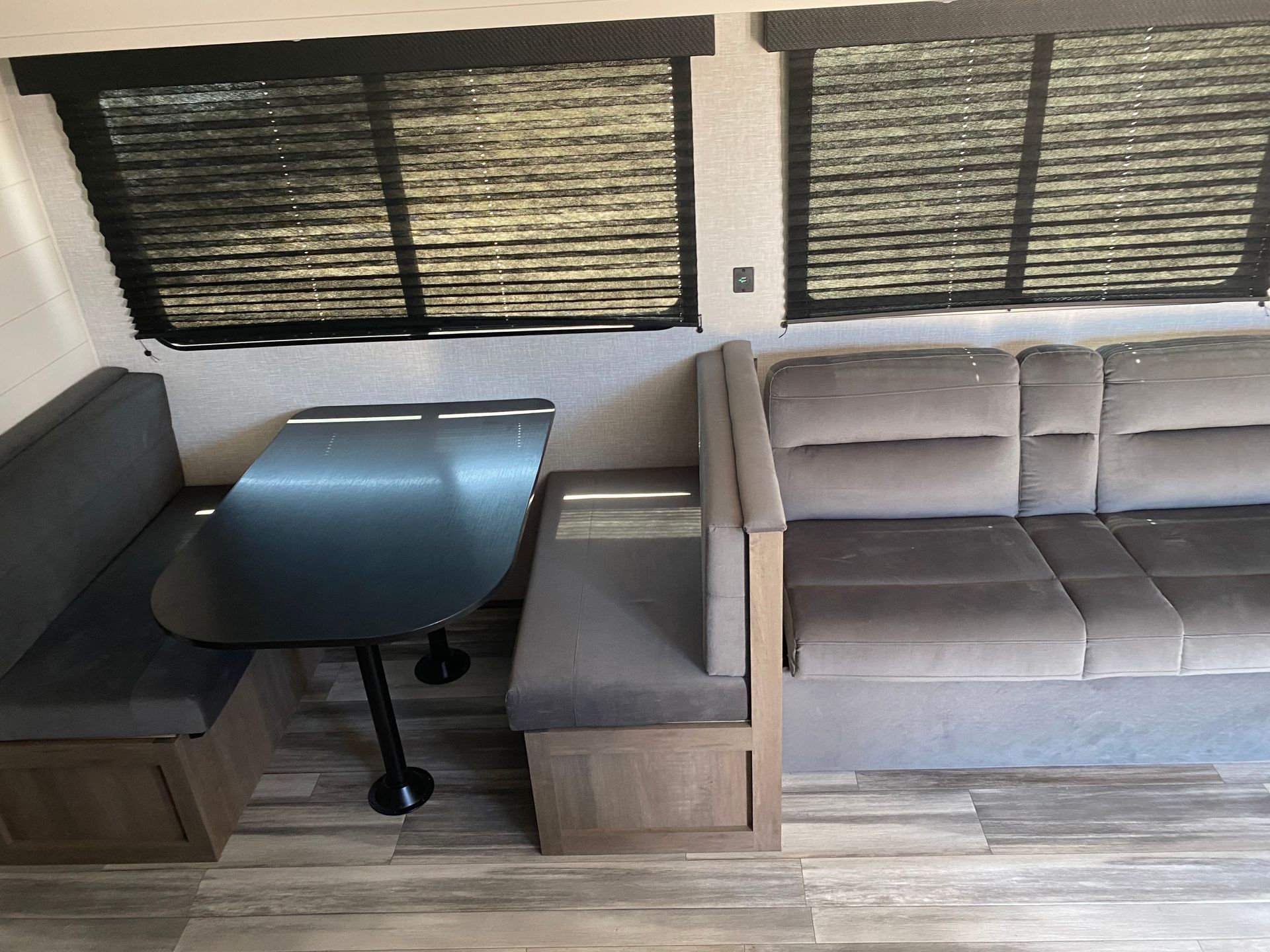 A rv with a couch and a table in it