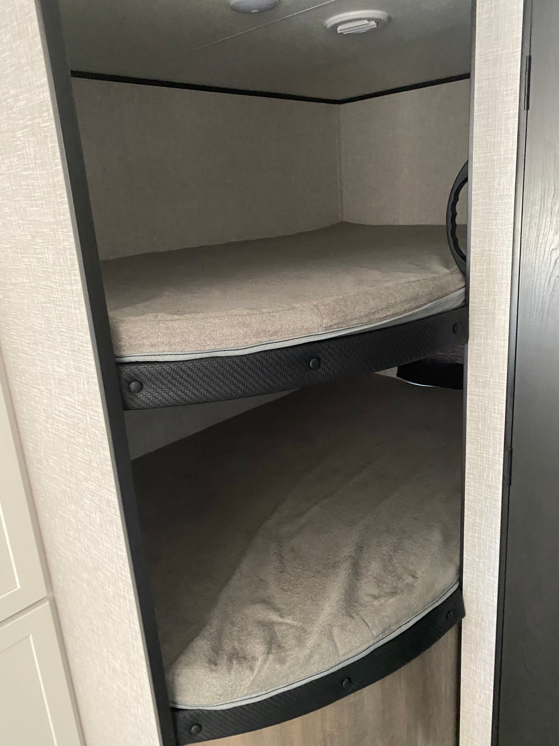 A closet with two bunk beds in it.