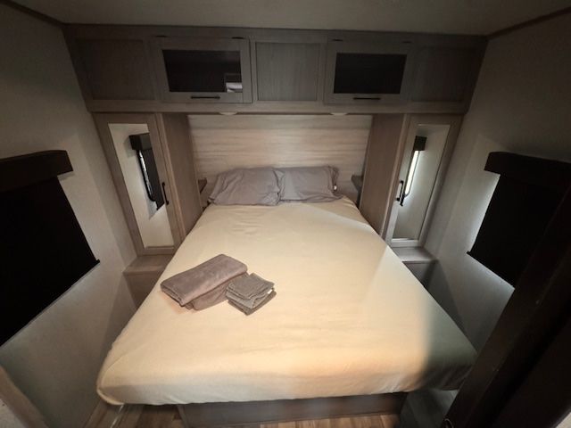 A bedroom with a king size bed and two nightstands