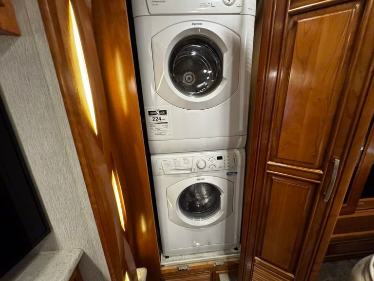 A washer and dryer are stacked on top of each other in a bathroom.