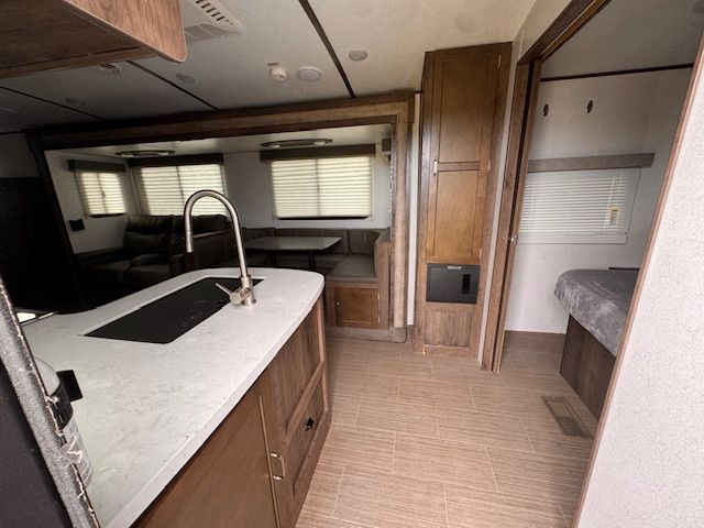 A kitchen in a rv with a sink and cabinets