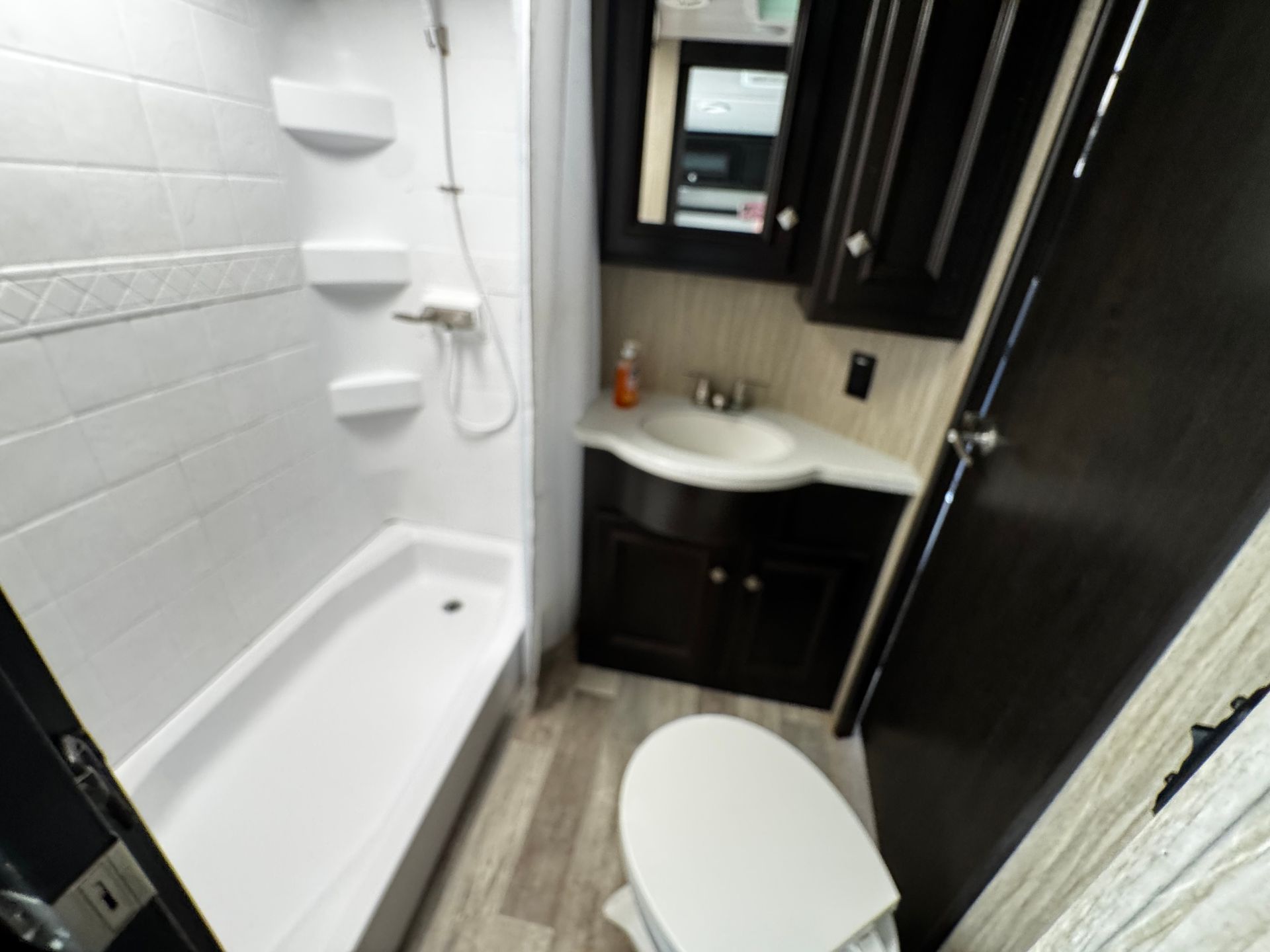 A bathroom with a toilet a sink and a bathtub