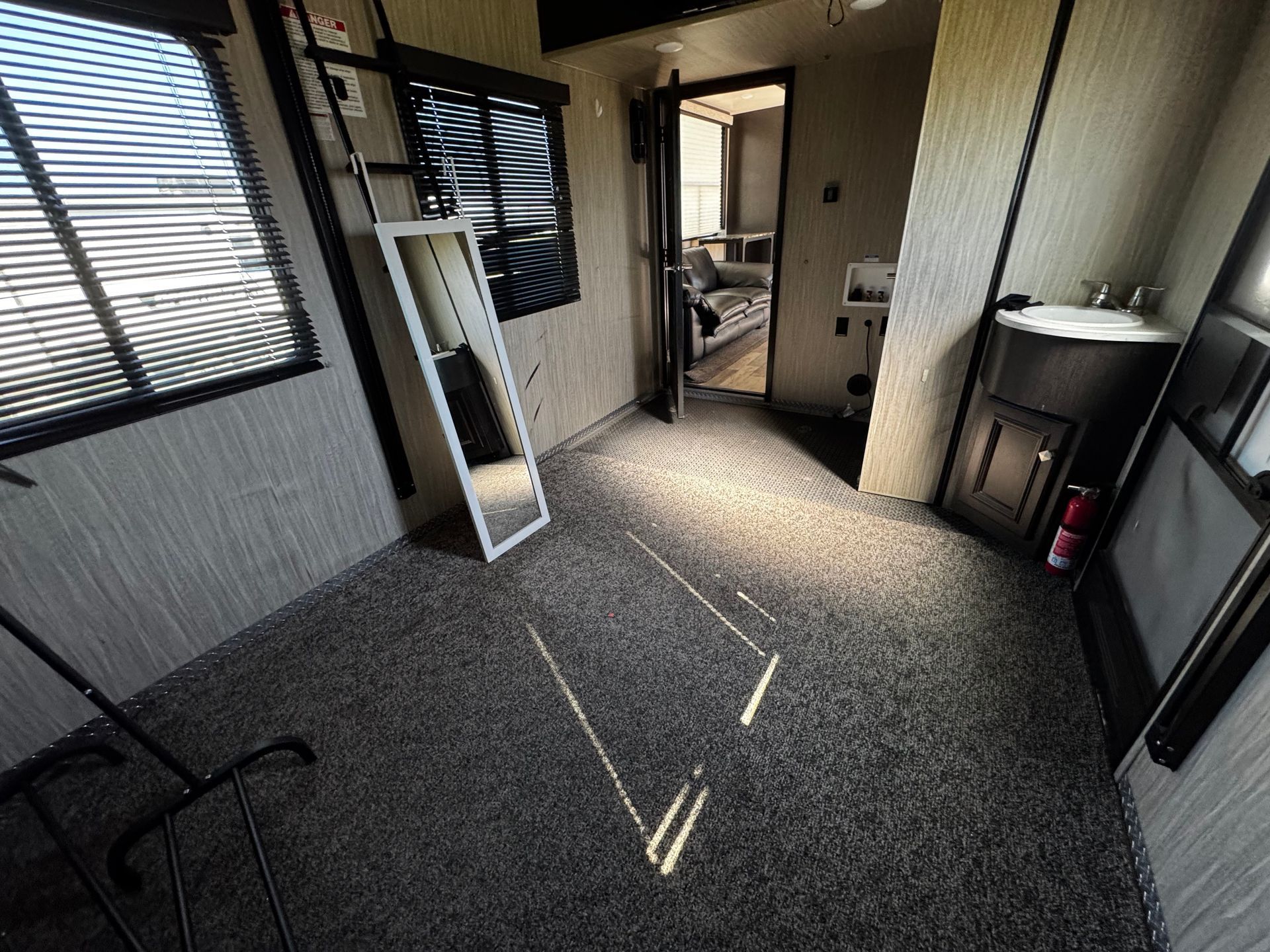 A room with a mirror and a sink in it