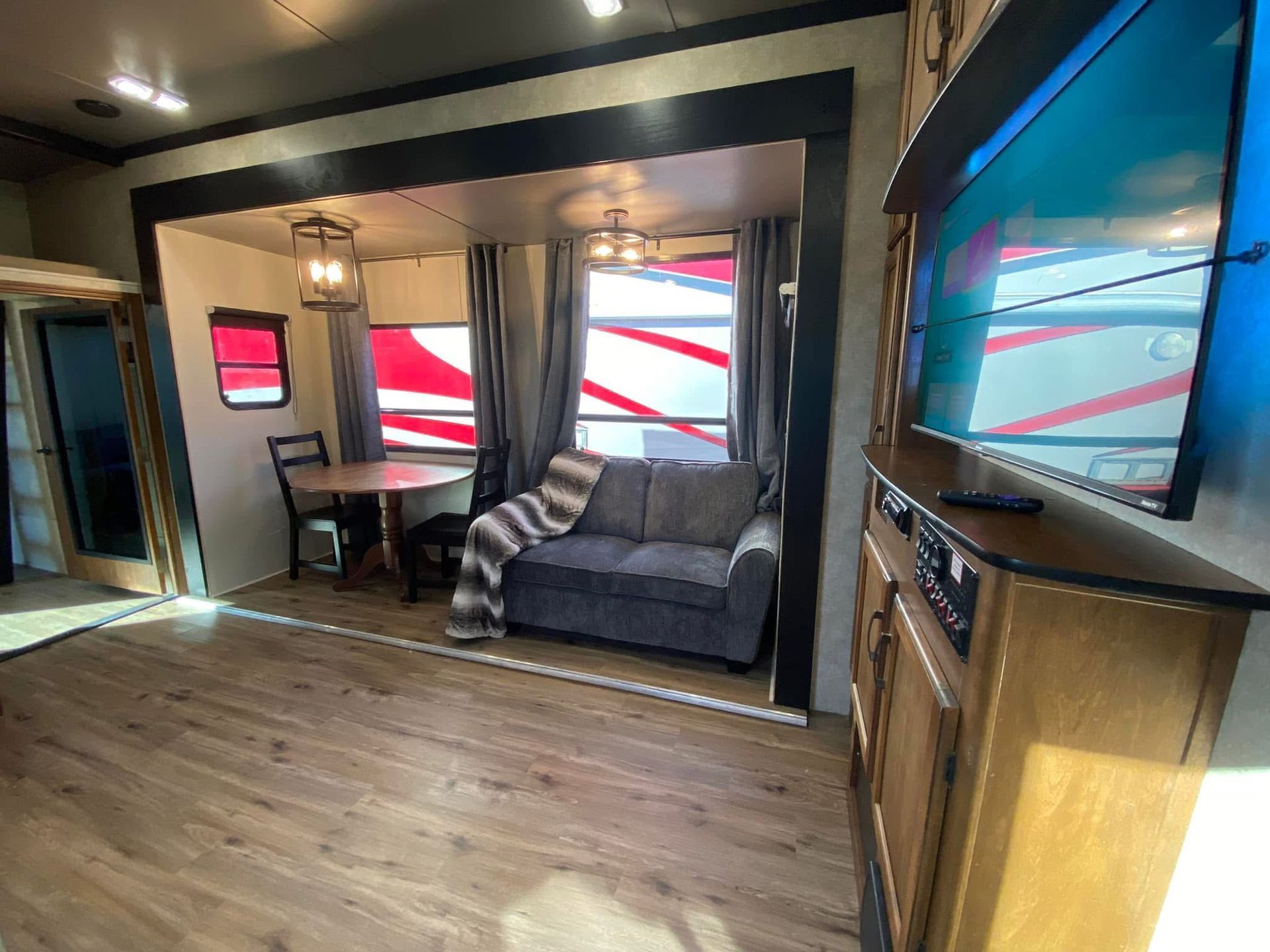 A living room with a couch , table and television.