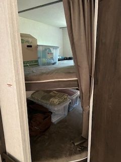A room with a bed and boxes in it.