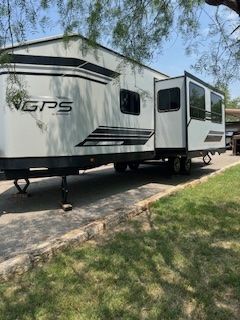 A white trailer is parked on the side of the road.