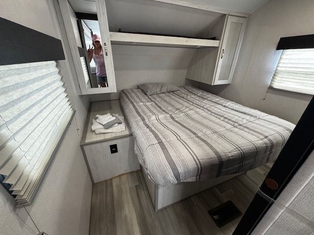 A small bedroom with a bed and a window