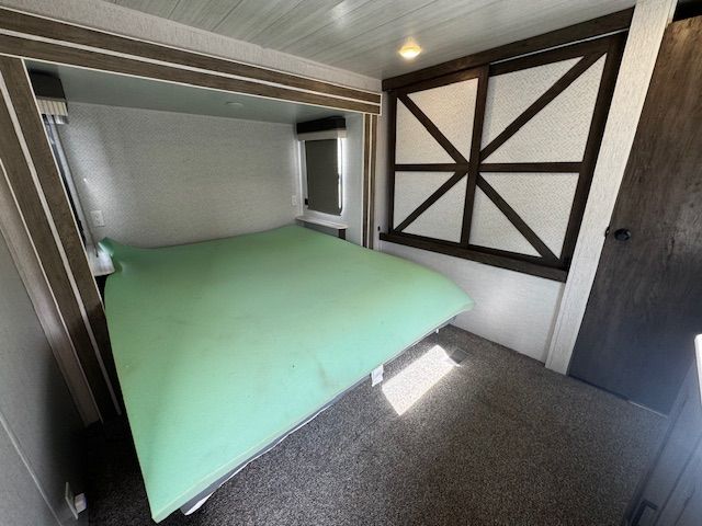 A bedroom with a bed and a window in it