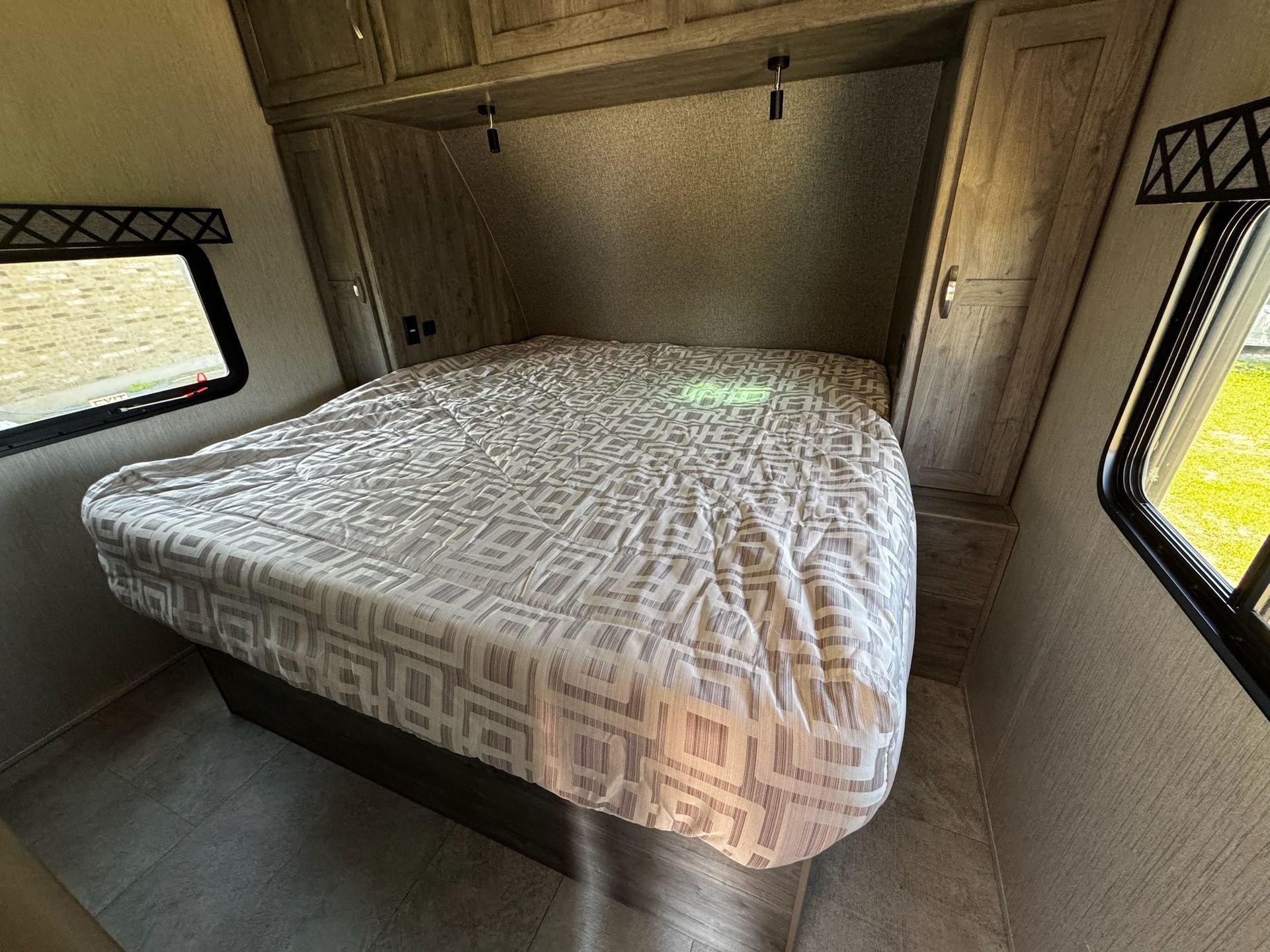 A bed with a mattress on top of it in a trailer.