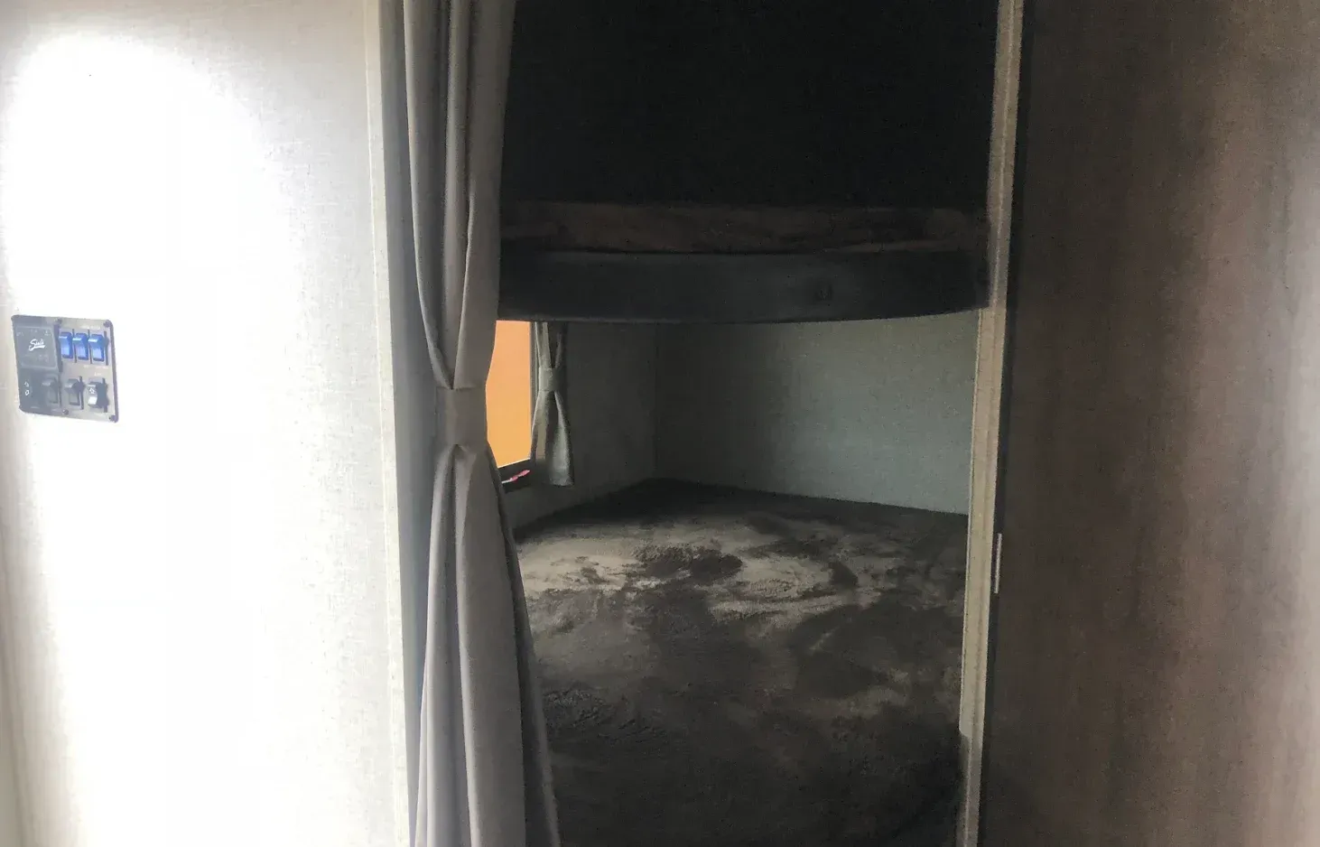 There is a bunk bed in the corner of the room.