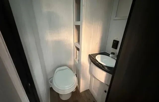 There is a toilet and a sink in the bathroom.