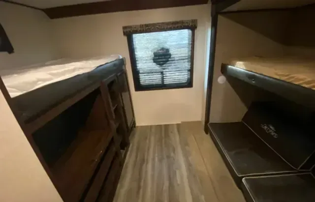 A room with bunk beds and a window in it