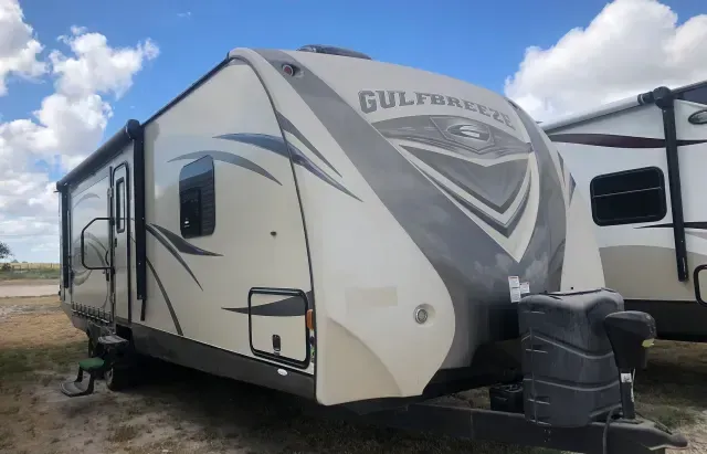 A gulf breeze trailer is parked in a field
